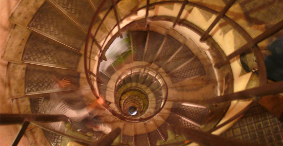 Person walking down spiral staircase